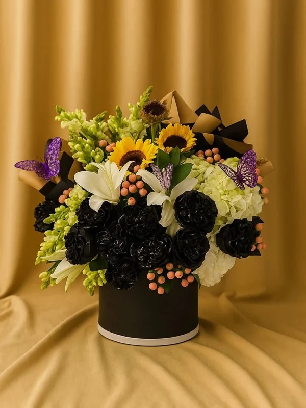 Arreglo de claveles negros con girasoles, lirios y mariposas moradas sobre cortina dorada