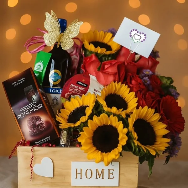Canasta de regalo con vino, chocolates Ferrero, girasoles y rosas rojas