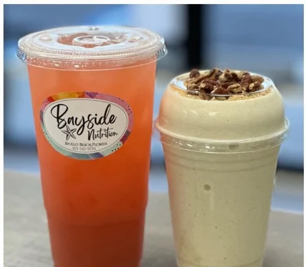 Orange loaded tea beside a shake topped with chopped pecans