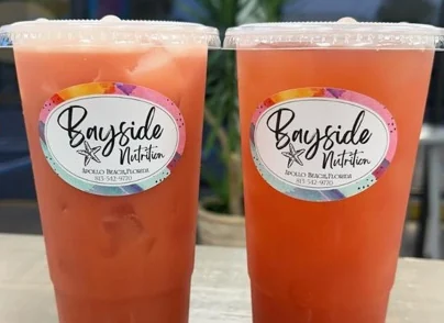 Two large coral-colored loaded teas side by side on the counter