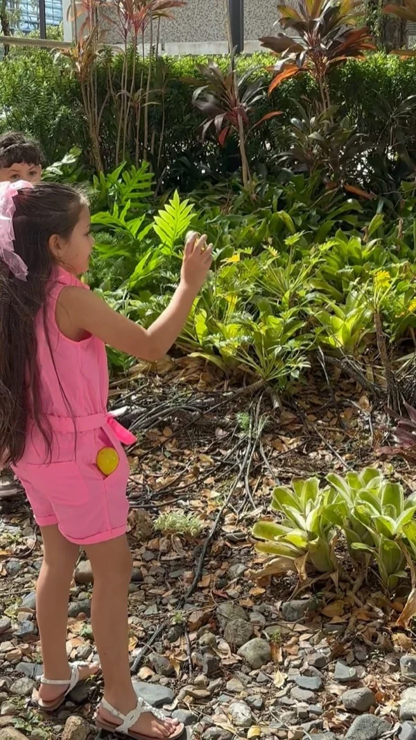 Niña explorando plantas y flores en una actividad al aire libre