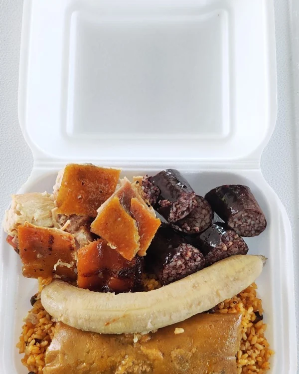 Plato completo: lechón, cuerito, morcilla, guineo, pastel y arroz con gandules